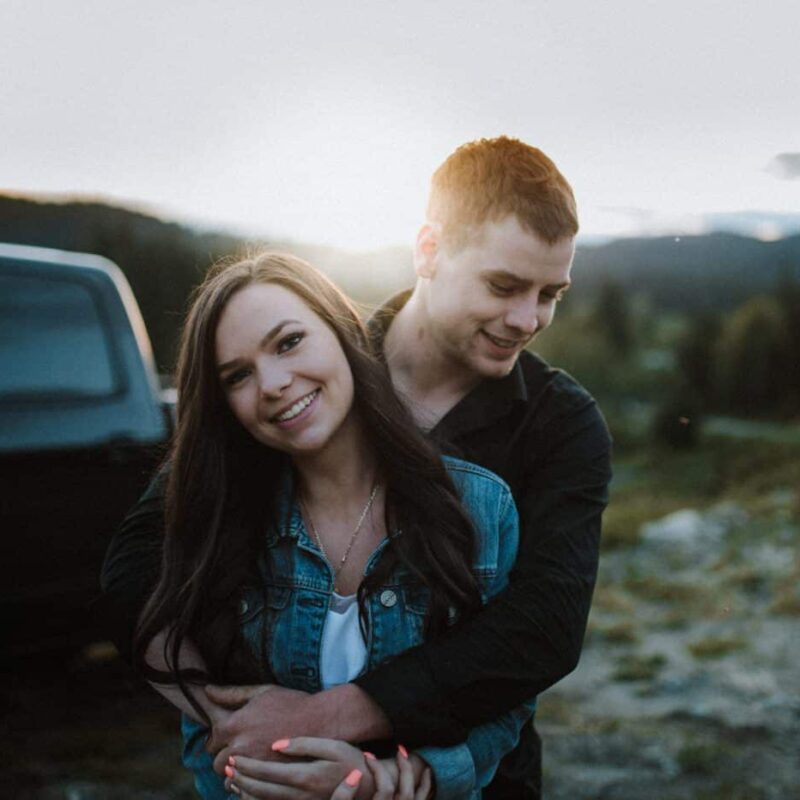 young couple embrace at sunset