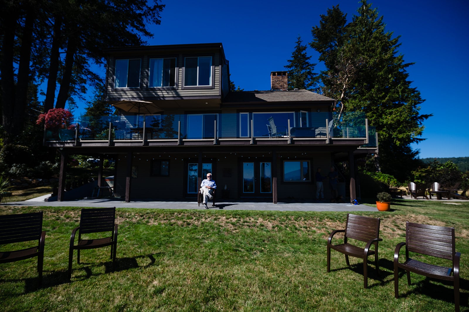 The father of the groom sits before the wedding ceremony site at his home in Halfmoon Bay, patiently waiting for the proceedings to start