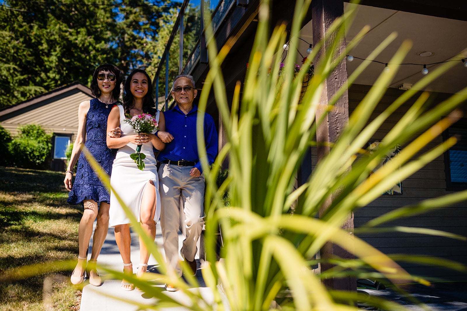 The bride walks down the garden aisle towards her groom near Sargent Bay, BC on the Sunshine Coast BC