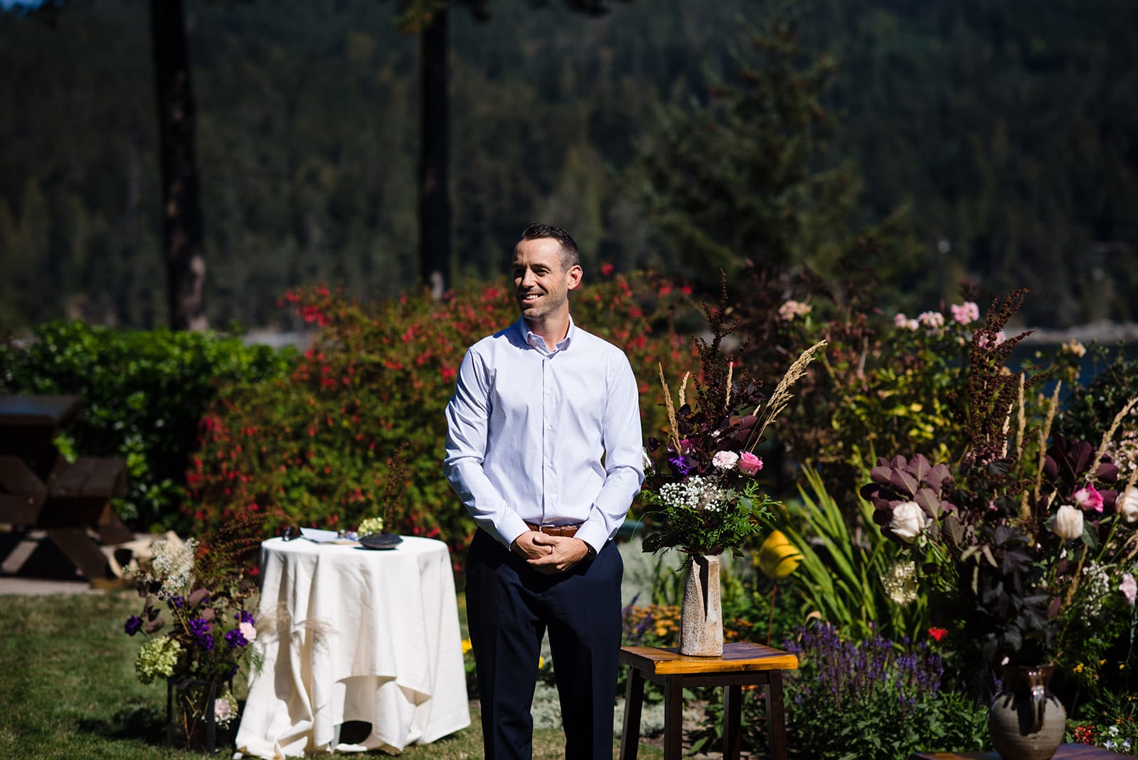 The groom smiles with love as he sees his bride for the first time just before they marry