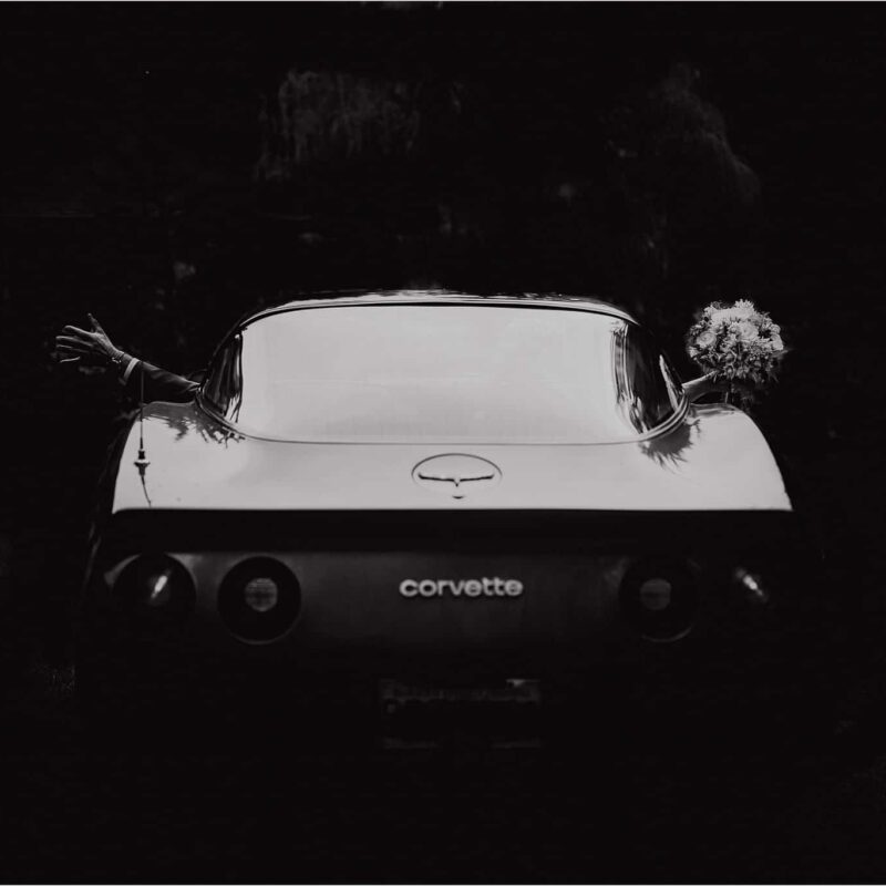 bride and groom depart in his 81 corvette in Halfmoon Bay