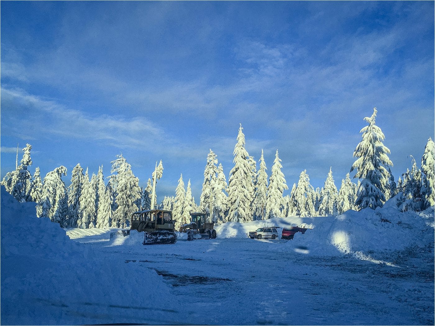 the parking lot at Dakota Ridge being plowed by big machines