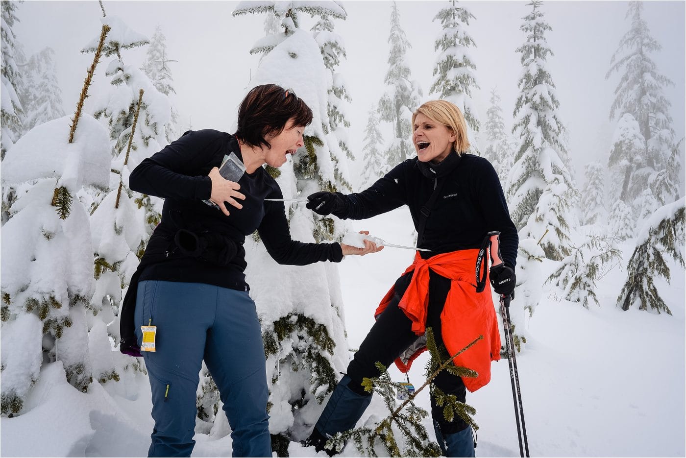 two friends play with icicles at a Dakota Ridge adventure