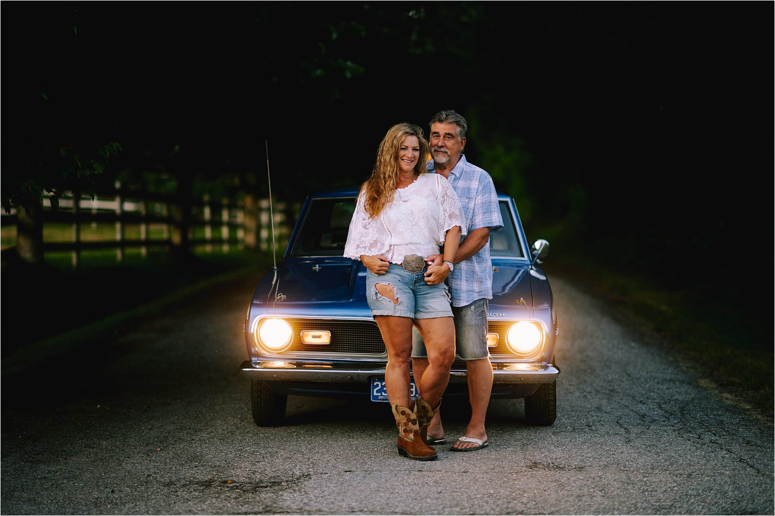 husband and wife in front of vintage car