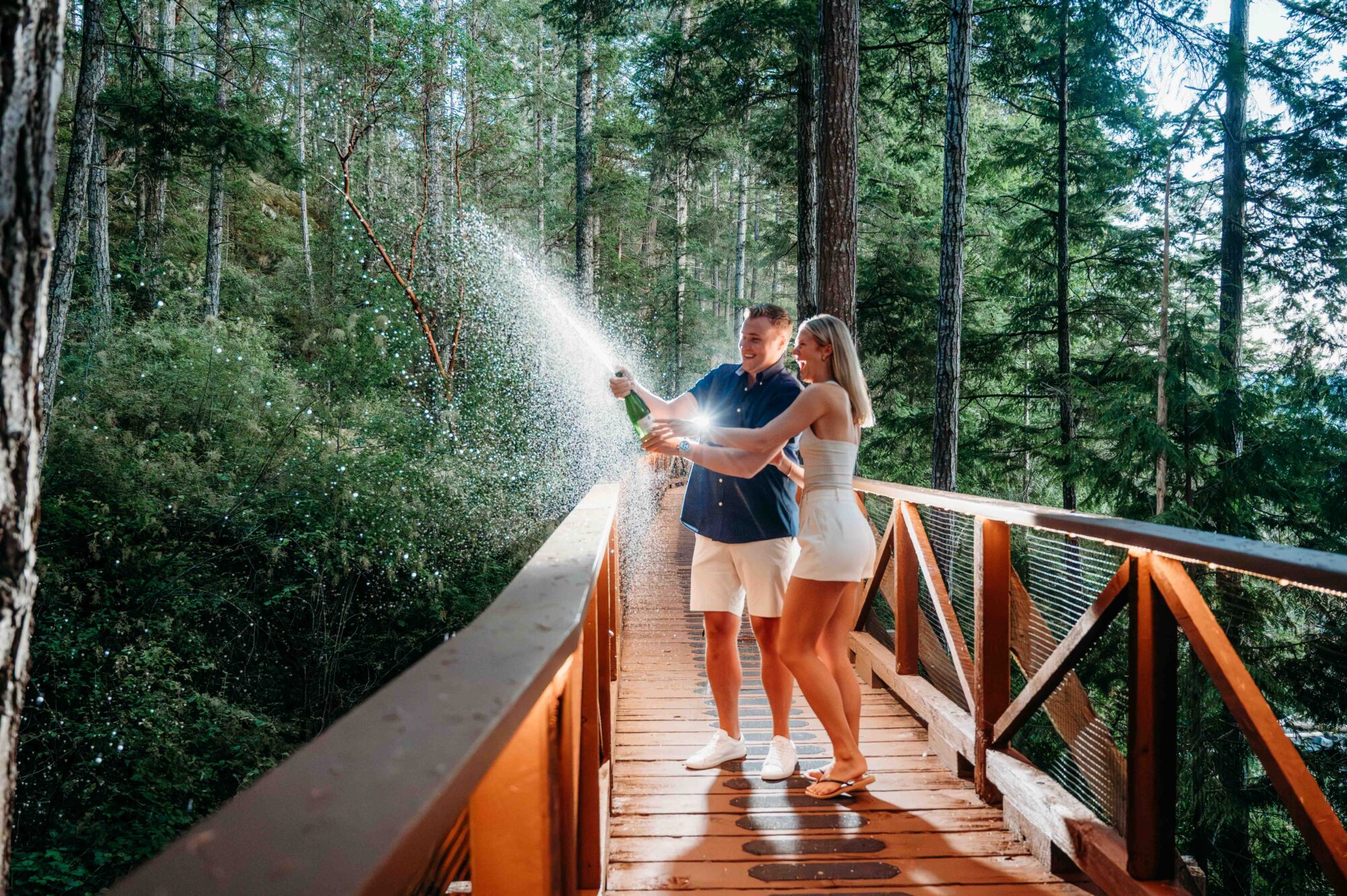 couple celebrating their proposal with champagne at Rockwater Resort on the Sunshine Coast BC