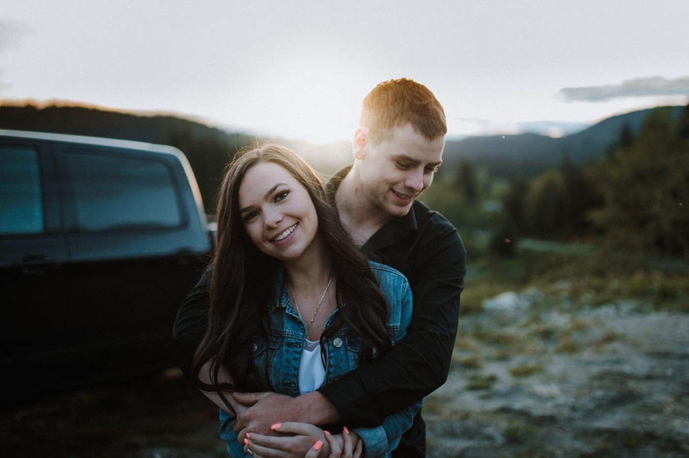 young couple hugging at sunset mini session