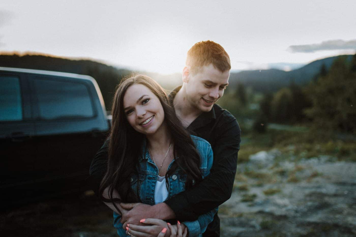 young couple embrace at sunset