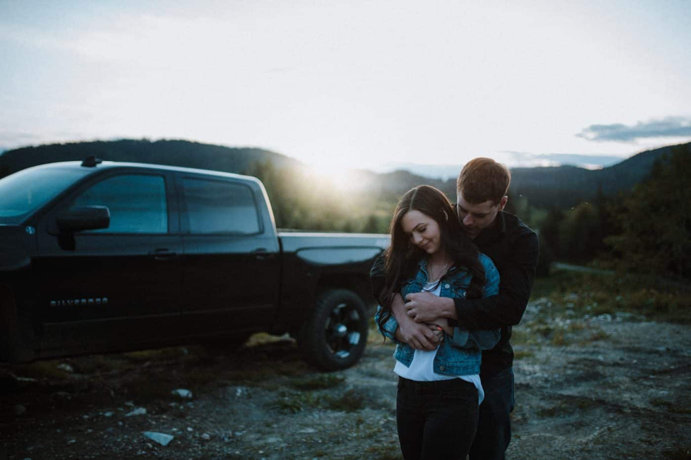 couple embrace by their truck at sunset on the Sunshine Coast BC