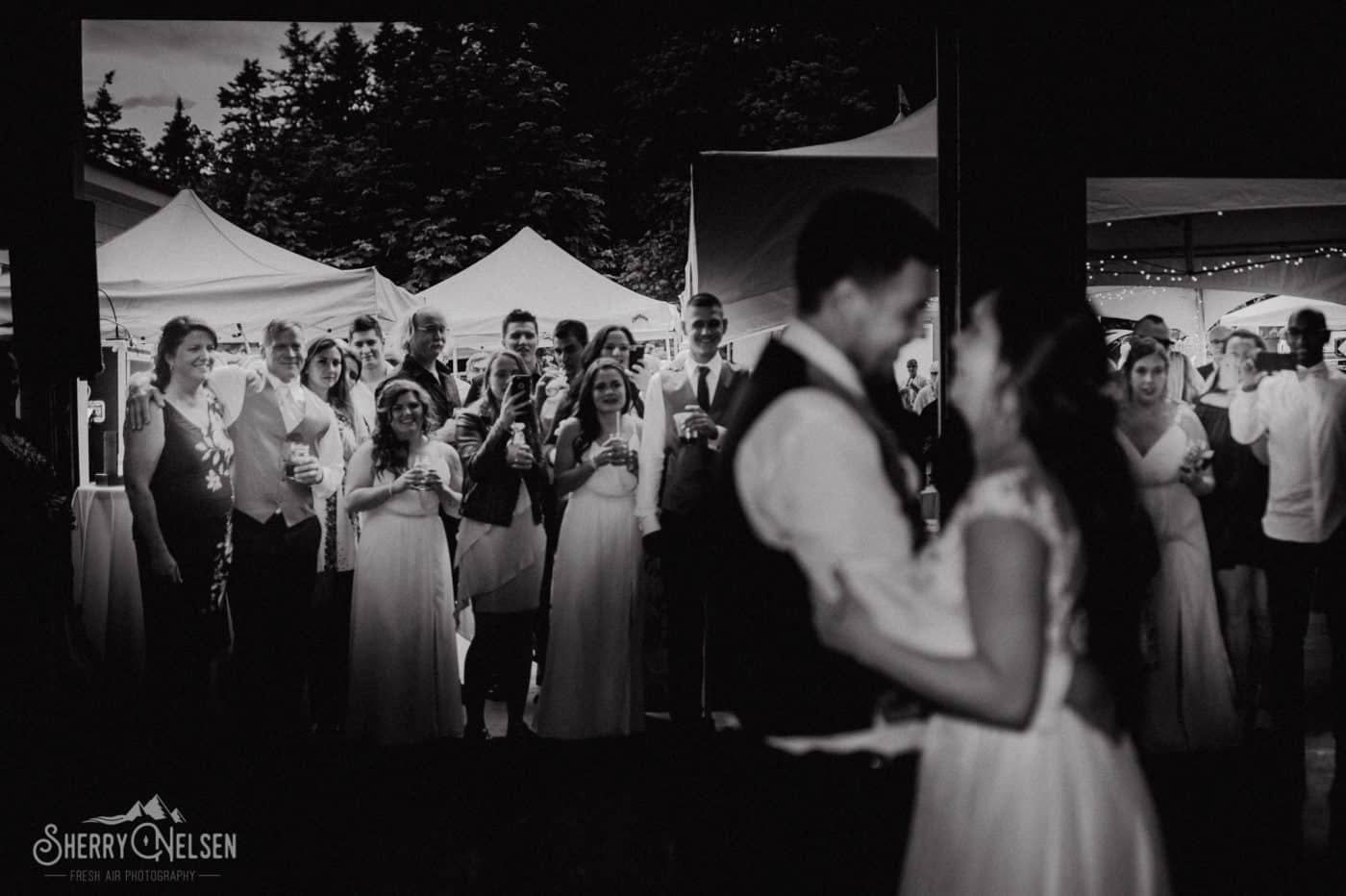 Bride and groom have their first dance as their friends and family look on in happiness at Shane & Shelbi's Sechelt wedding