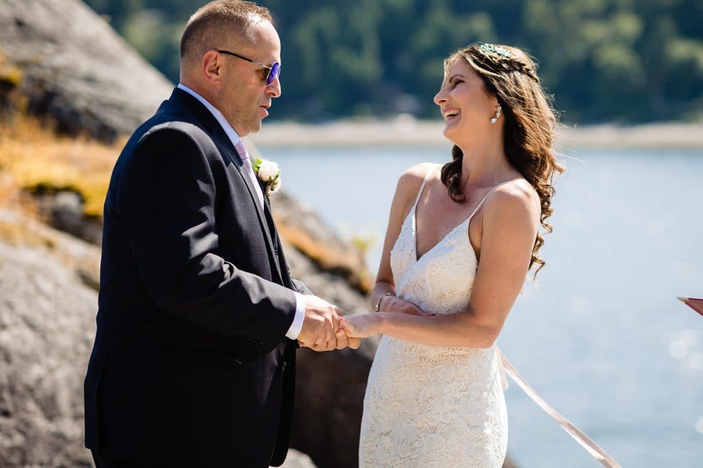 groom makes bride laugh during wedding vow exchange