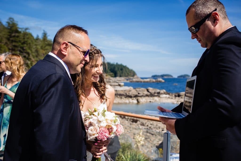 bride and groom skype with loved one during sunshine coast wedding ceremony