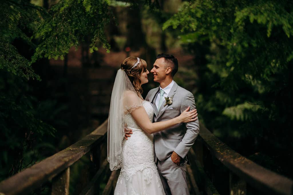 Bride and Groom on a bridge in the forest