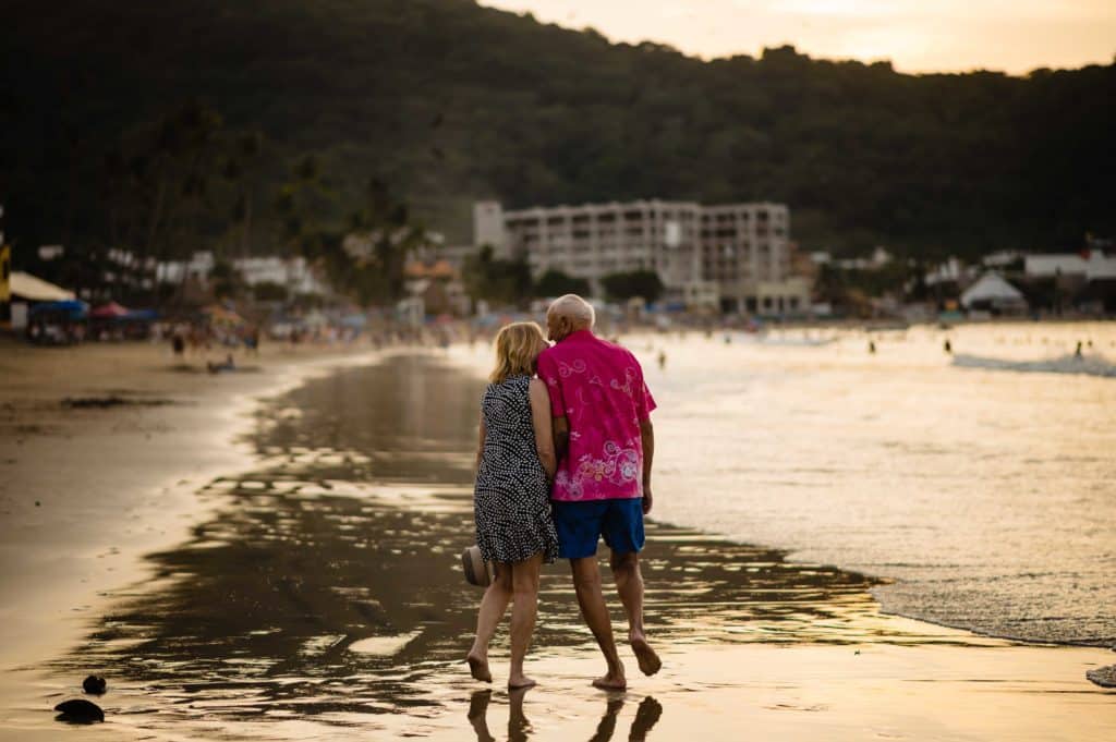 a couple who has been married for 59 years celebrates with a sunset walk on the beach in Rincon de Guayabitos