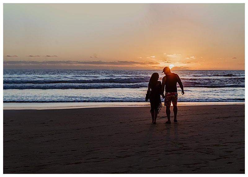 couple walking into the sunset on the beach Troncones Mexico