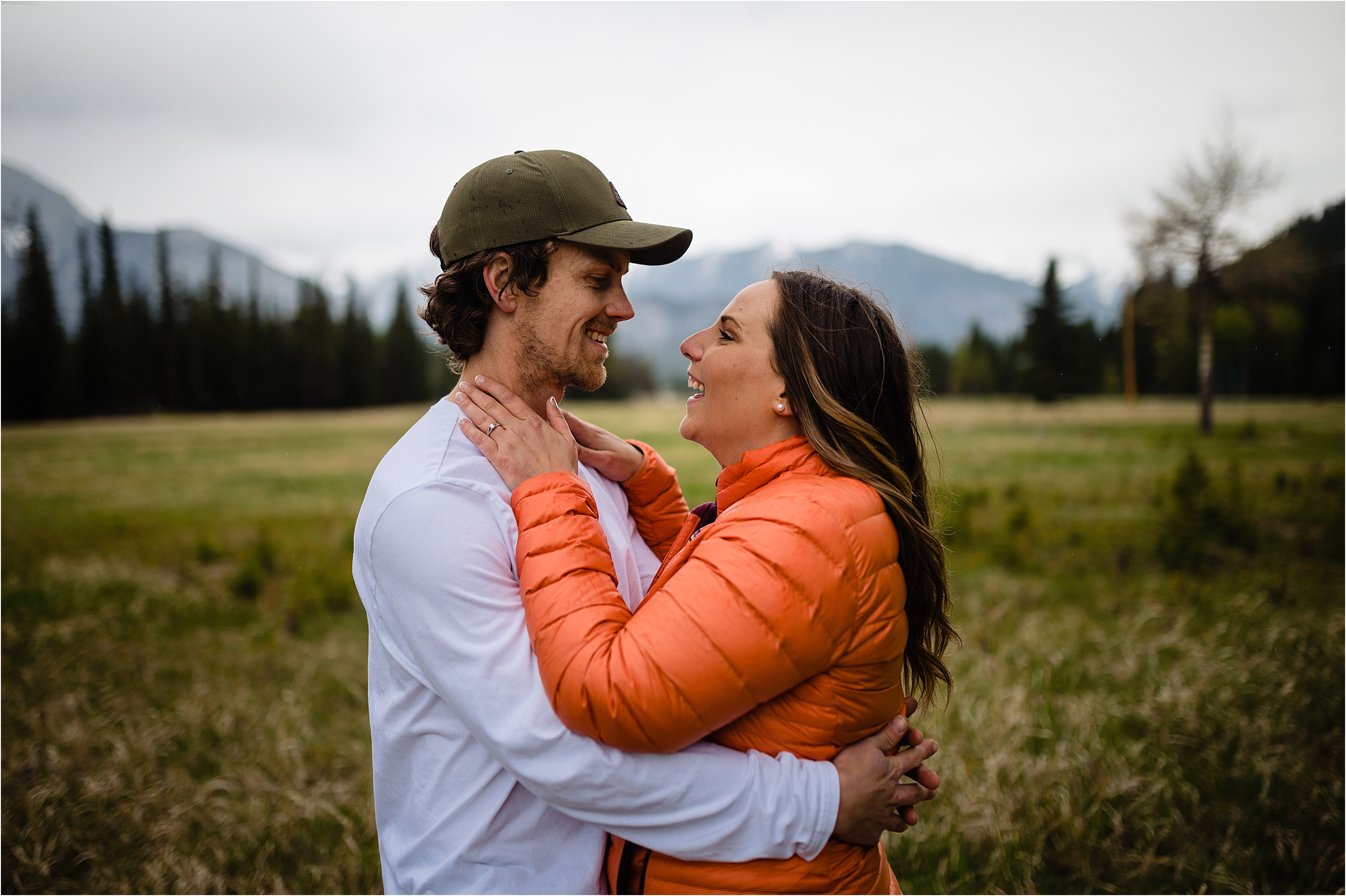 couple smile and embrace in Banff