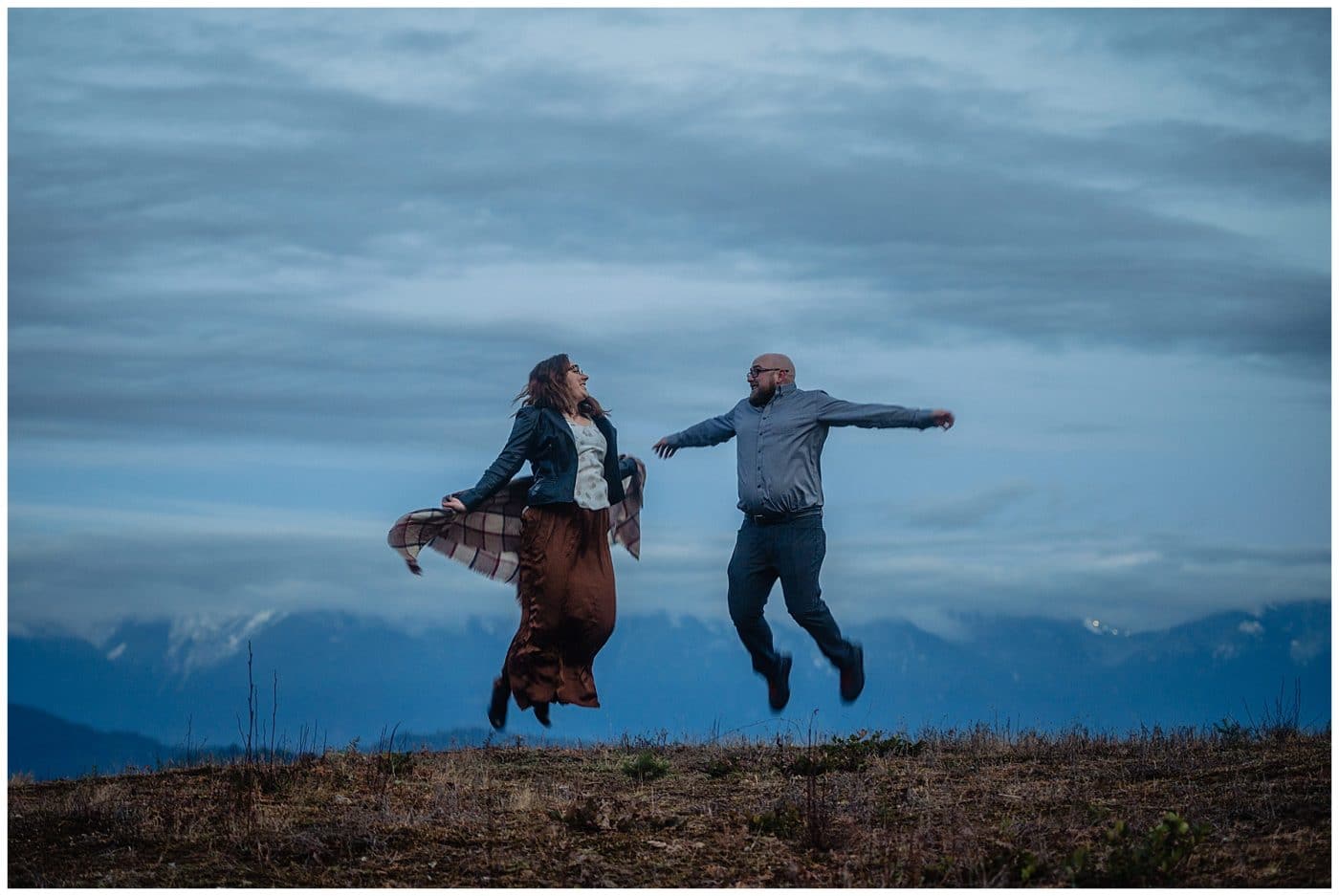 An engagement story and the couple jump in the air in happiness Sunshine Coast BC