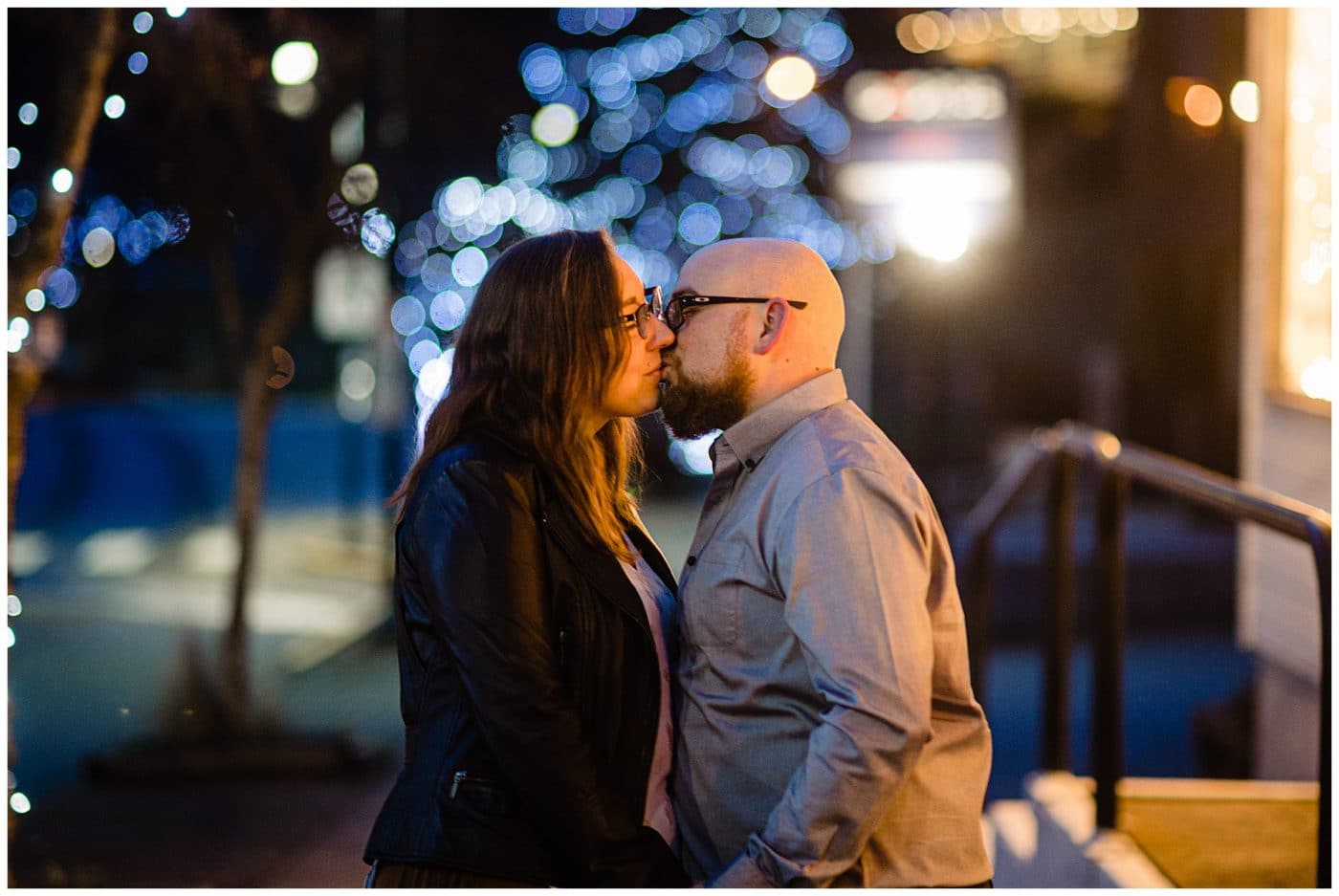 Newly engaged couple kiss under the lights in Gibsons