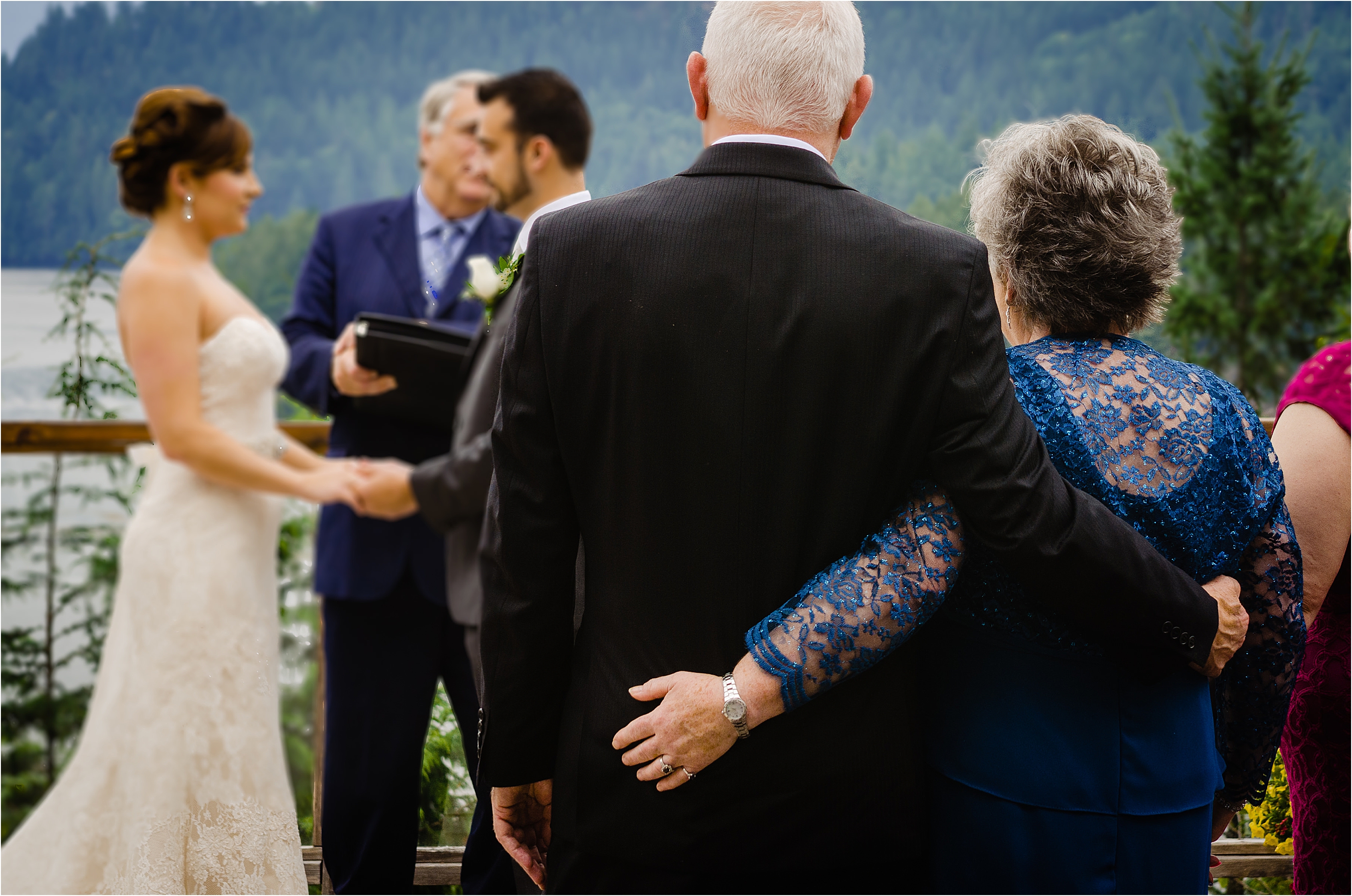 mom and dad watch their daughter marry at the West Coast Wilderness Lodge