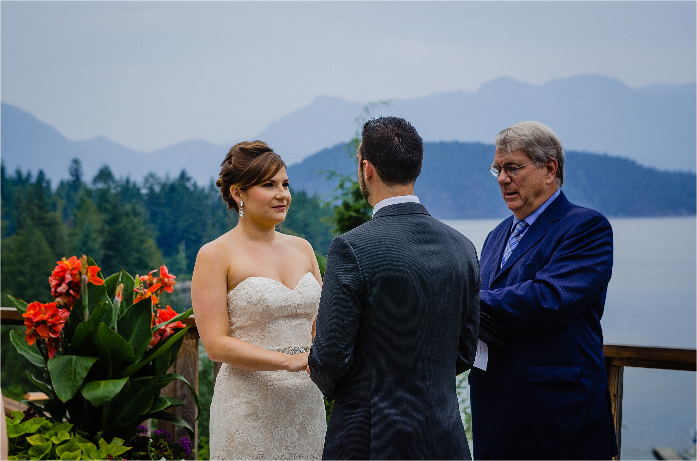 bride and groom say their vows before commissioner on the deck of the West Coast wilderness Lodge