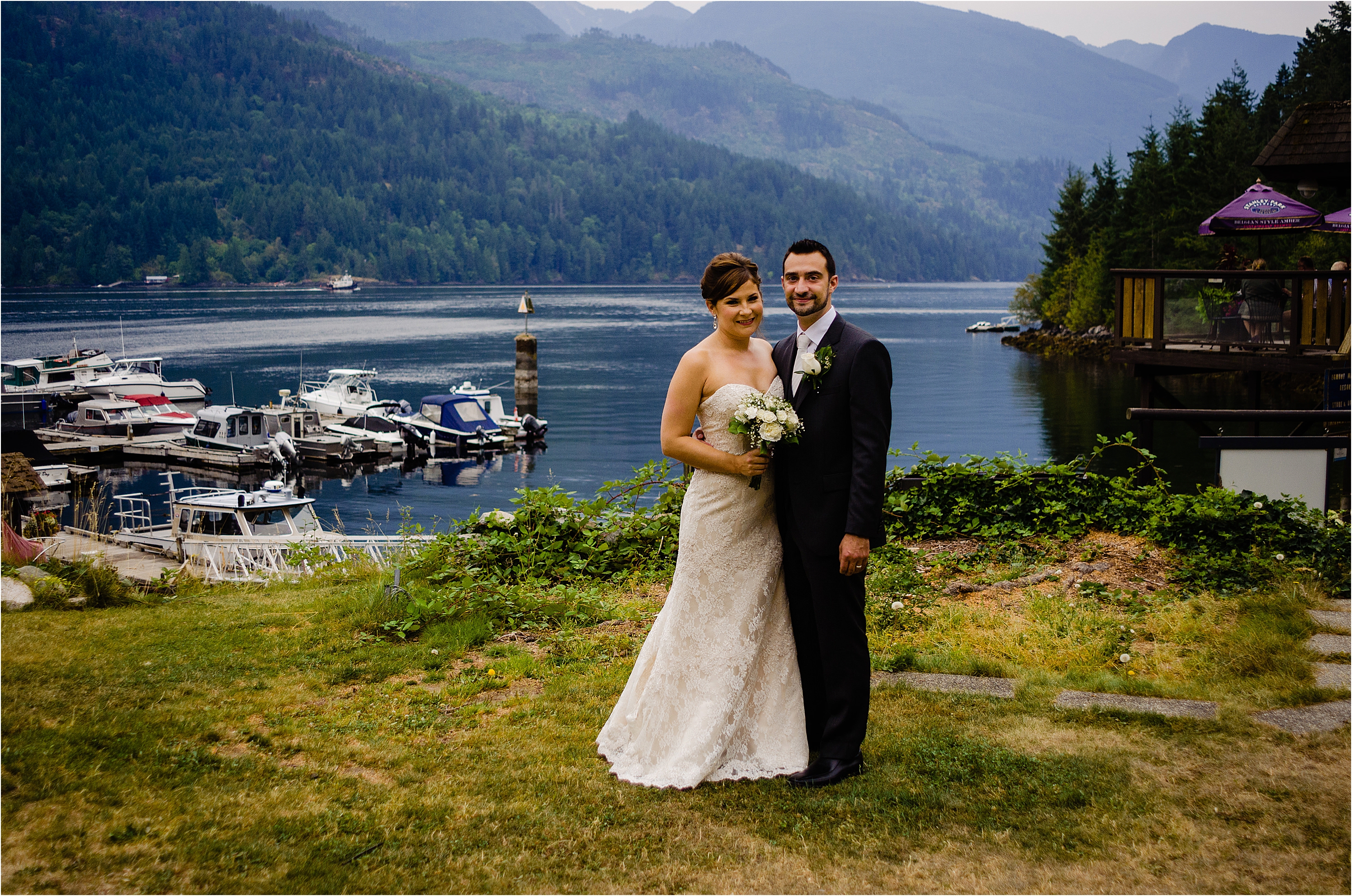 bride and groom pose near the Back Eddy Pub in Egmont