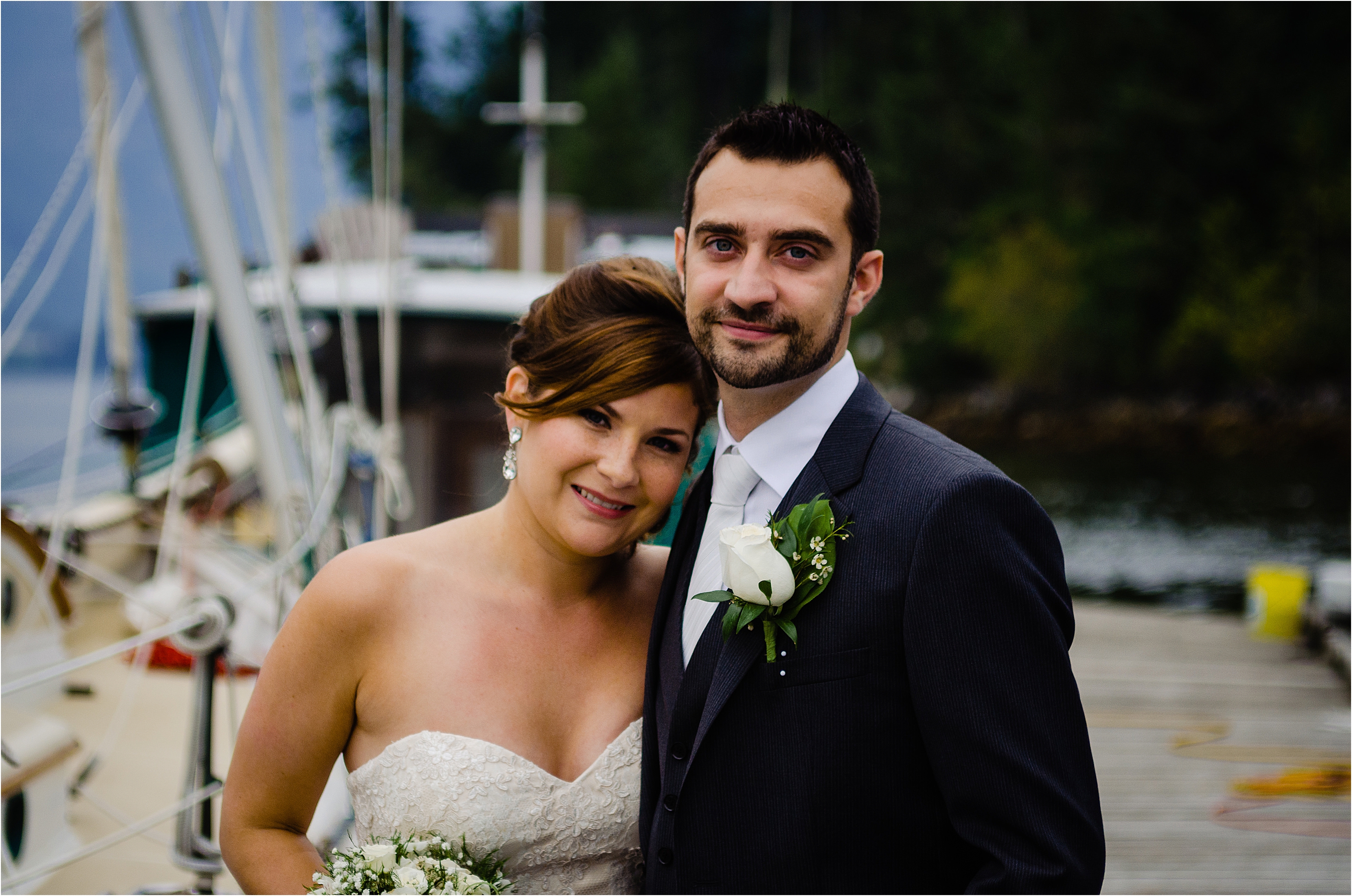 bride and groom pose for a portrait on the wharf in egmont