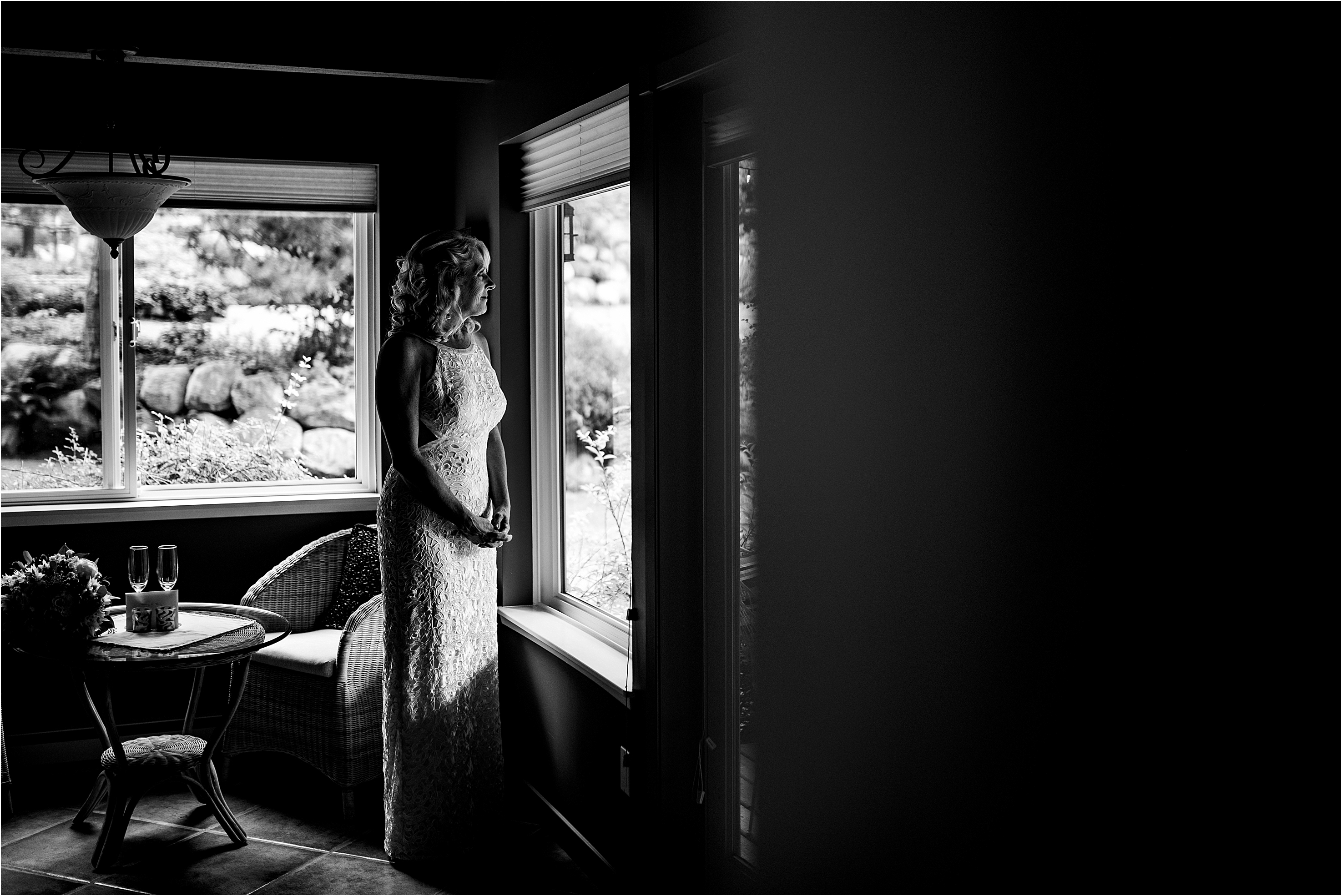 Bride looks out the window hoping to see her groom waiting for her at the Valhalla House Wedding