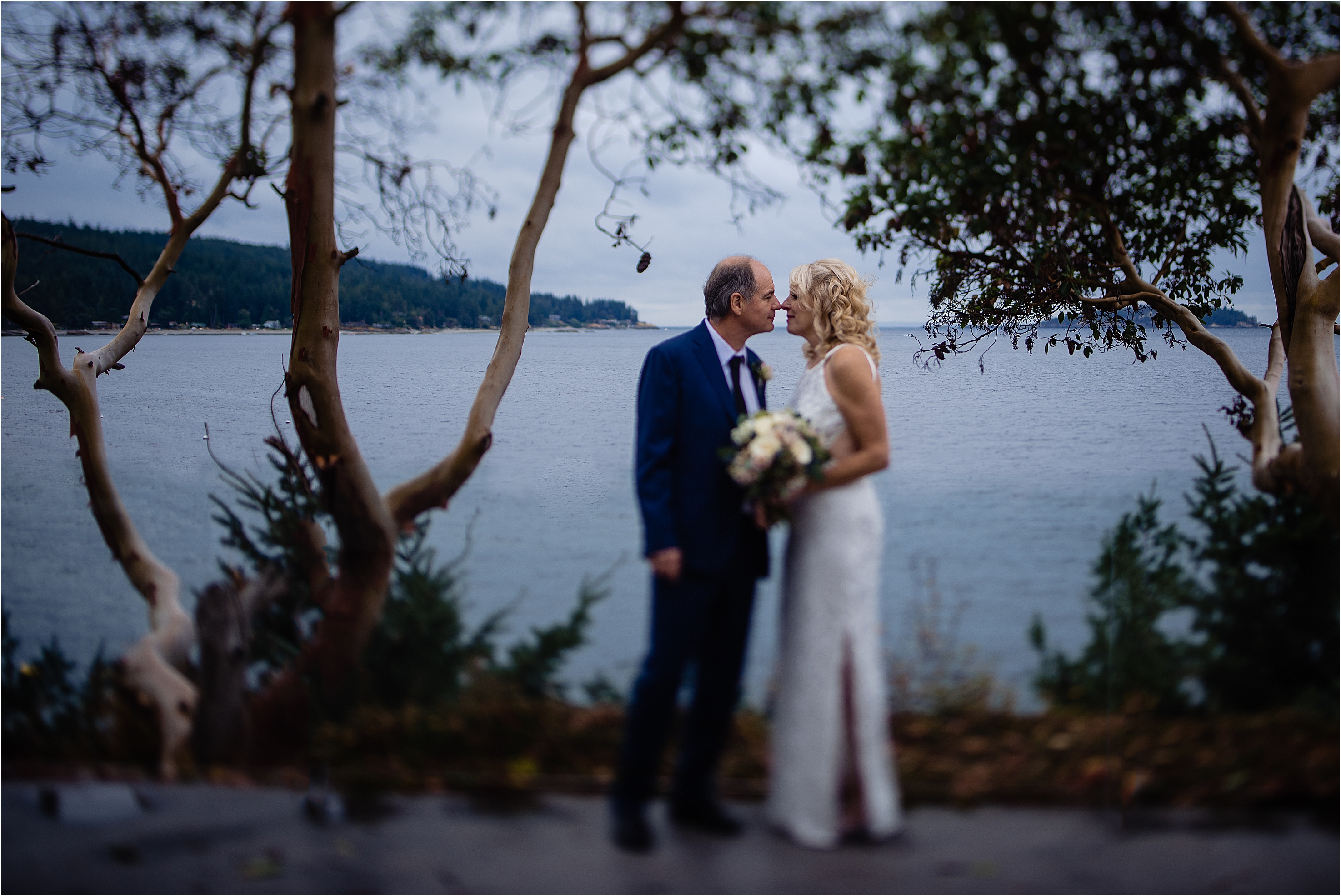 Bride and groom amongst the Arbutus trees in Halfmoon Bay