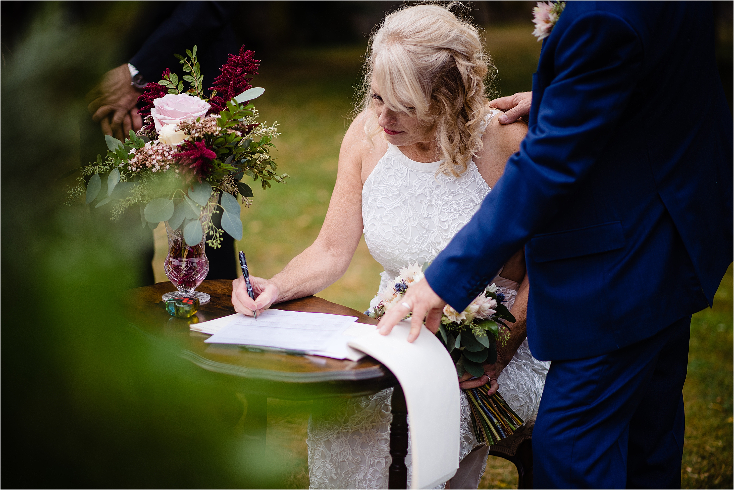 bride signs the registry in halfmoon bay wedding photo taken by Sherry NElsen