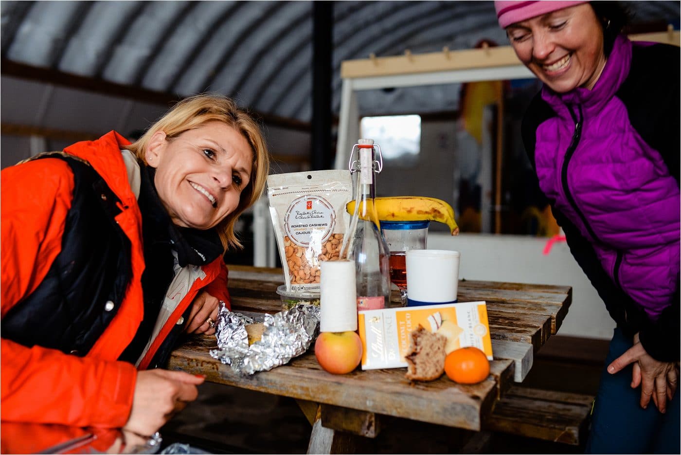 two friends warm in the quonset hut at a Dakota Ridge Adventure