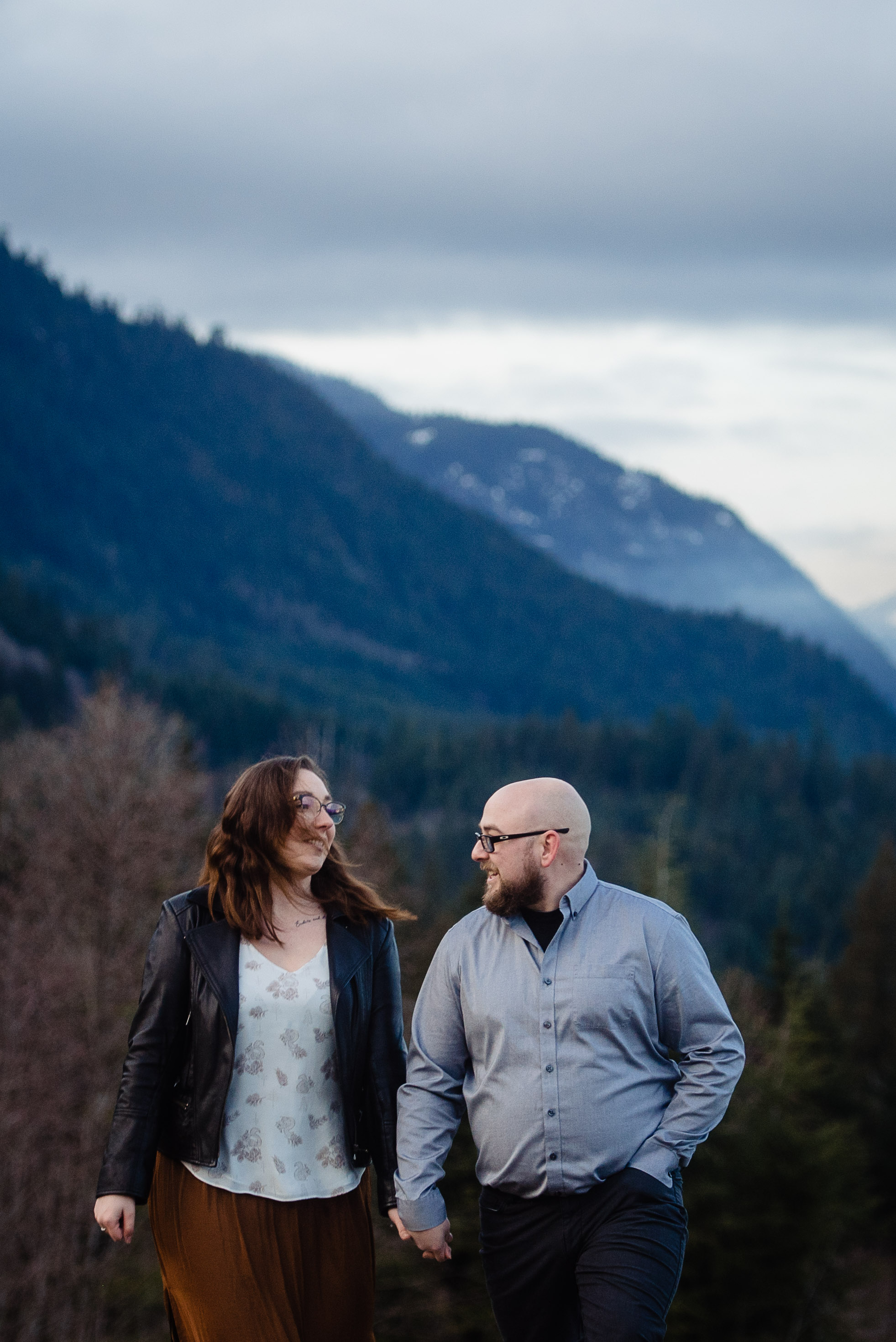 Chad and Alysha walk in the mountains at their engagement session