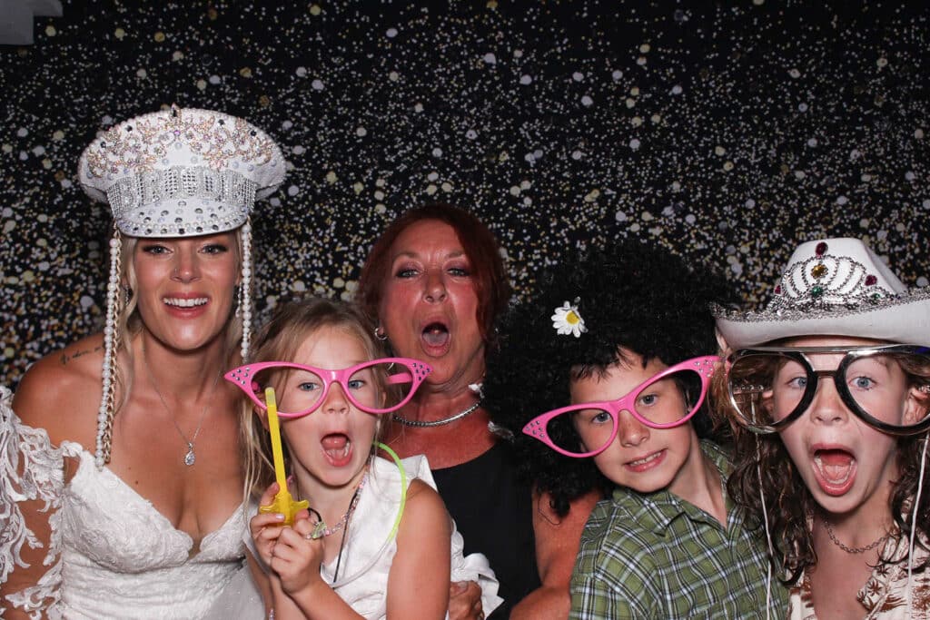 Bride snaps a pic with her wedding guests inside her Sunshine Coast Photo Booth rental