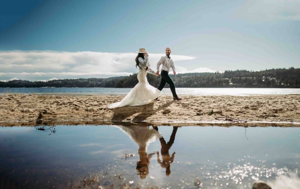 A stylish bride and groom stroll on the beach captured by their BC wedding photographer on the Sunshine Coast
